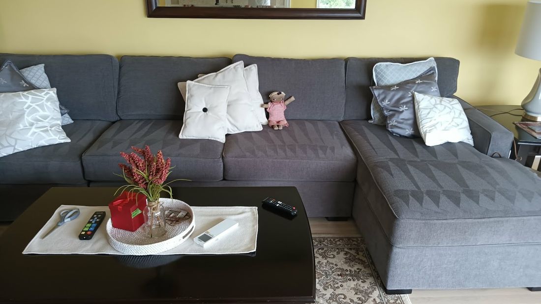 Tidy living room with grey sectional and styled coffee table