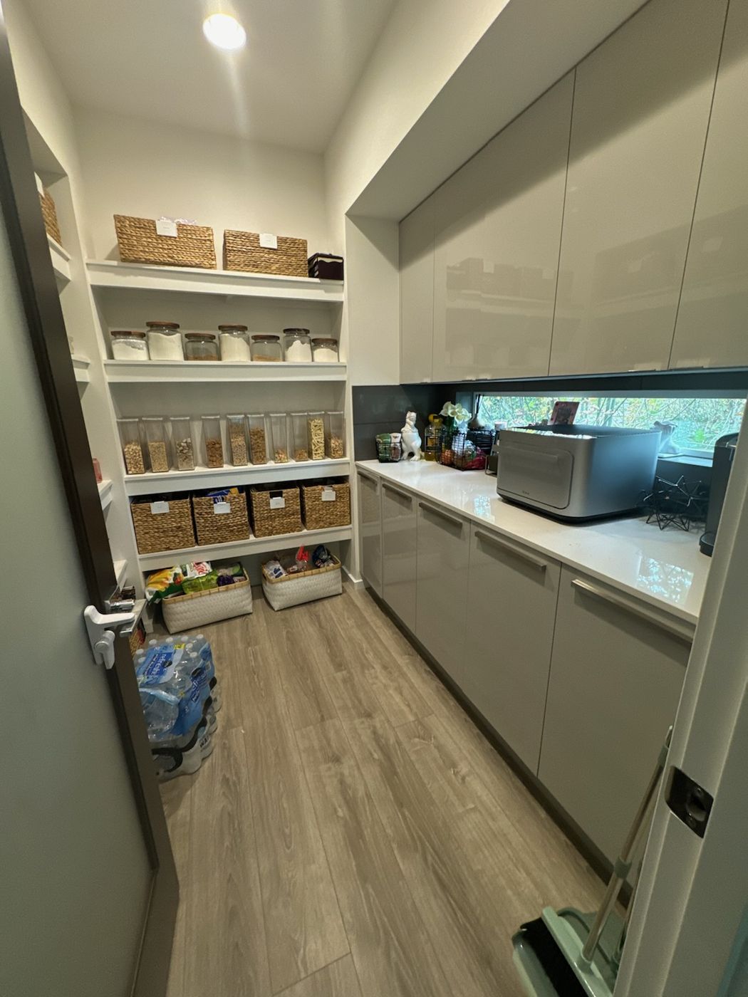 Organized walk-in pantry with baskets and labeled jars