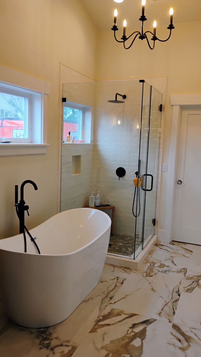 Bright bathroom with freestanding tub, glass shower and marble floor